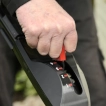 Close-up of a user adjusting the variable speed drive control on the Cobra MX484SPCE handle