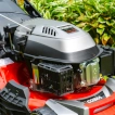 Detailed close-up of the 173cc petrol engine mounted on the Cobra MX484SPCE lawnmower deck