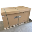 A large, fully sealed cardboard shipping box securely strapped to a wooden pallet, demonstrating standard unassembled machinery delivery.